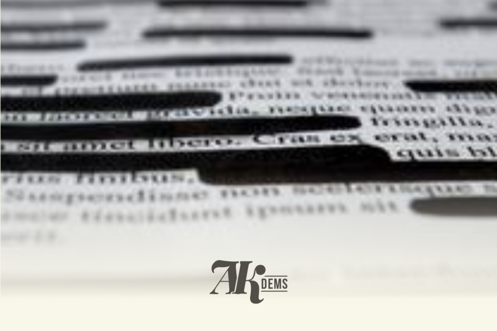Blurred grayscale graphic showing stacked text lines with a prominent 'AK DEMS' logo near the bottom.