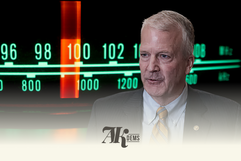 Portrait of a suited man in front of a neon-green stock market ticker with a prominent red vertical marker behind him.