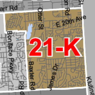 Map showing a brown highlighted district outlined in white with a bold red '21-K' label over it, surrounded by street names.