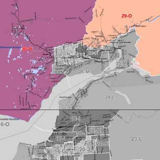 Color-coded territorial map with purple, pink and orange zones around a gray central area; sector labels include 29-O, 30-O, and 26-M with road lines.