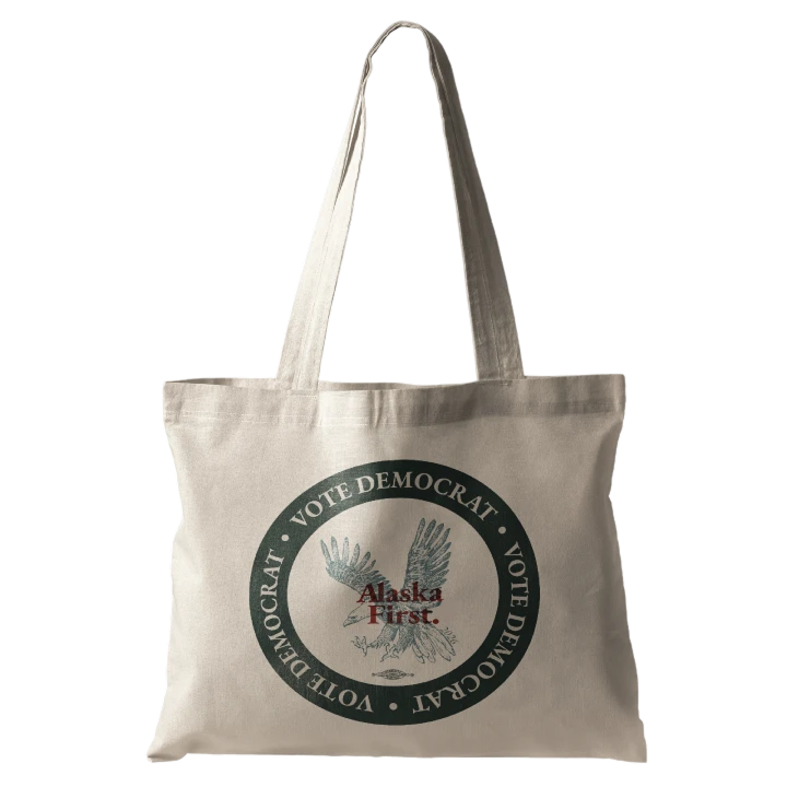 Beige tote bag with a circular 'Vote Democrat' emblem around an eagle and 'Alaska First' in the center.